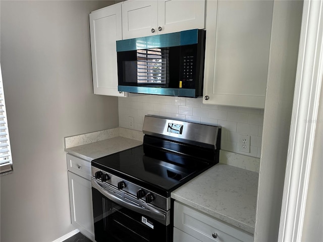 652 Roaring Dr Unit 234, Altamonte Springs, FL 32714 - kitchen with appliances with stainless steel finishes, tasteful backsplash, white cabinetry, and light stone counters