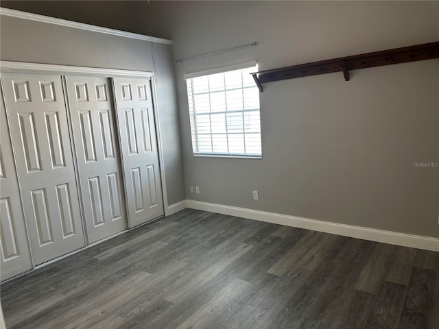652 Roaring Dr Unit 234, Altamonte Springs, FL 32714 - unfurnished bedroom with dark wood-style floors, baseboards, and a closet