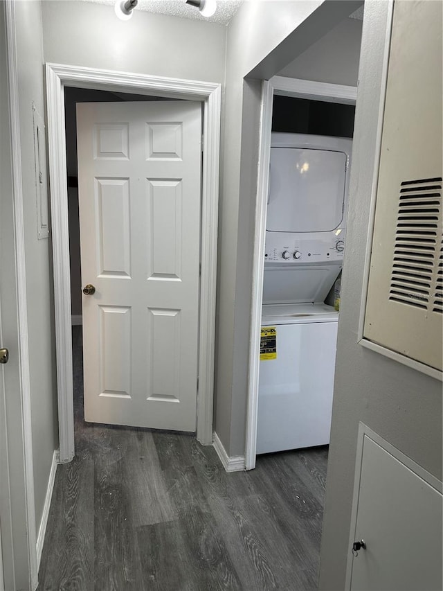 652 Roaring Dr Unit 234, Altamonte Springs, FL 32714 - laundry room with stacked washer / dryer, dark wood-style flooring, and baseboards