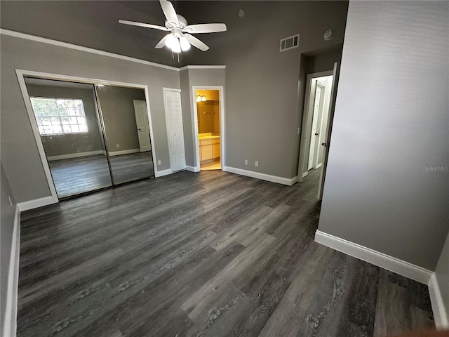 652 Roaring Dr Unit 234, Altamonte Springs, FL 32714 - unfurnished bedroom featuring baseboards, dark wood-style floors, ensuite bathroom, and ceiling fan