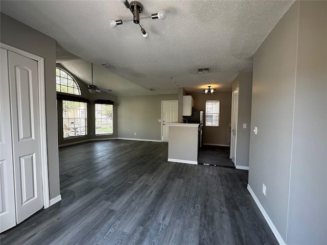 652 Roaring Dr Unit 234, Altamonte Springs, FL 32714 - unfurnished living room featuring a textured ceiling, dark wood-style floors, baseboards, ceiling fan, and vaulted ceiling
