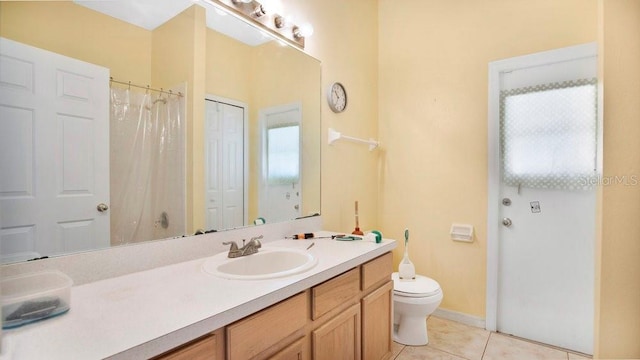 5203 Jasmine Trace Ln, Kissimmee, FL 34758 - full bathroom with vanity, toilet, tile patterned flooring, curtained shower, and baseboards