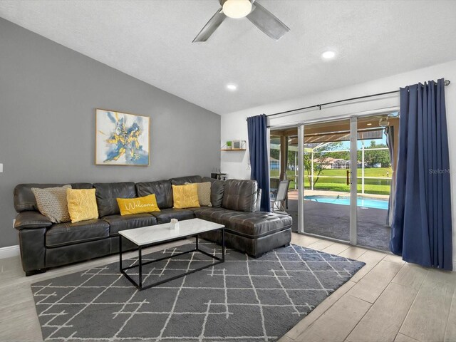 703 Sunridge Woods Blvd, Davenport, FL 33837 - living room featuring lofted ceiling, wood finished floors, ceiling fan, recessed lighting, and a textured ceiling