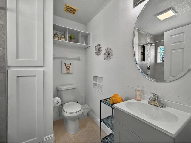 703 Sunridge Woods Blvd, Davenport, FL 33837 - bathroom with toilet, vanity, wood finished floors, baseboards, and a shower