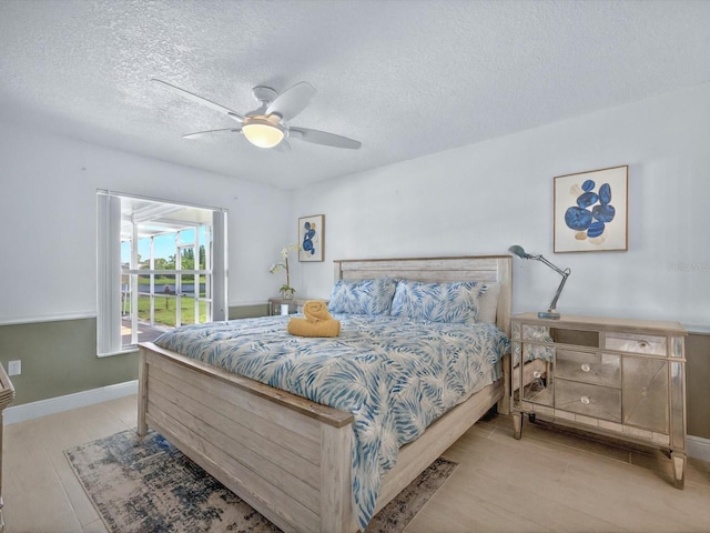 703 Sunridge Woods Blvd, Davenport, FL 33837 - bedroom featuring a textured ceiling, baseboards, and a ceiling fan