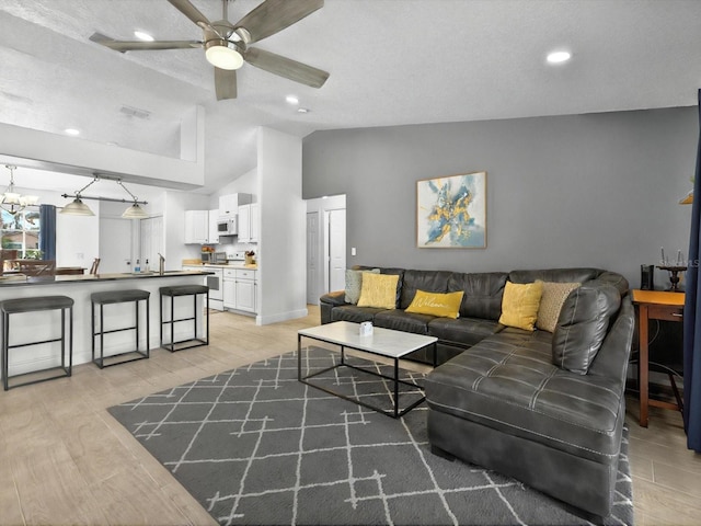 703 Sunridge Woods Blvd, Davenport, FL 33837 - living area featuring vaulted ceiling, a ceiling fan, light wood-type flooring, recessed lighting, and baseboards