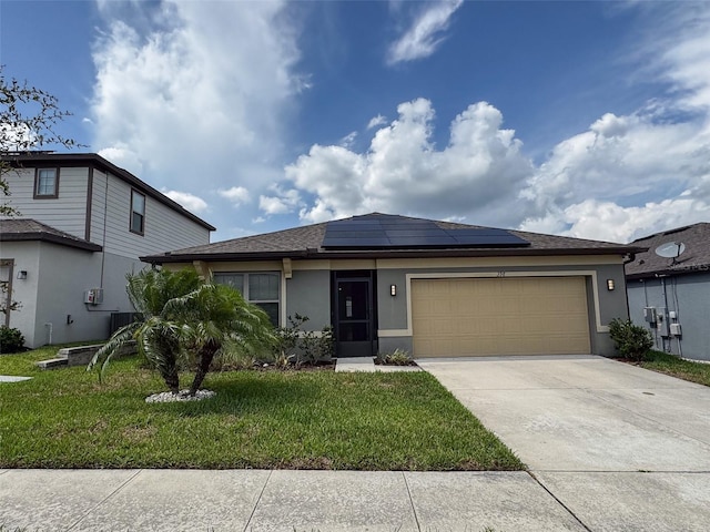 398 Citrus Isle Loop, Davenport, FL 33837 - view of front facade featuring stucco siding, solar panels, a front lawn, driveway, and a garage