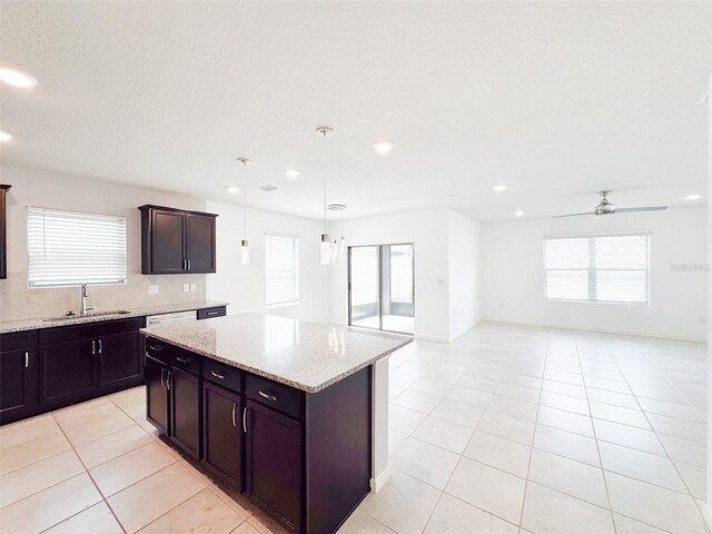 398 Citrus Isle Loop, Davenport, FL 33837 - kitchen featuring a sink, light tile patterned floors, open floor plan, recessed lighting, and a center island
