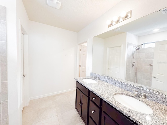 398 Citrus Isle Loop, Davenport, FL 33837 - bathroom with double vanity, tiled shower, baseboards, and tile patterned flooring