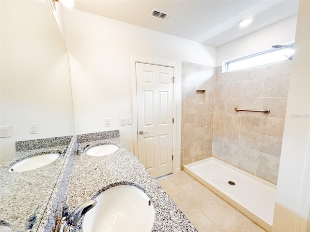 398 Citrus Isle Loop, Davenport, FL 33837 - bathroom with tile patterned flooring, double vanity, and a tile shower