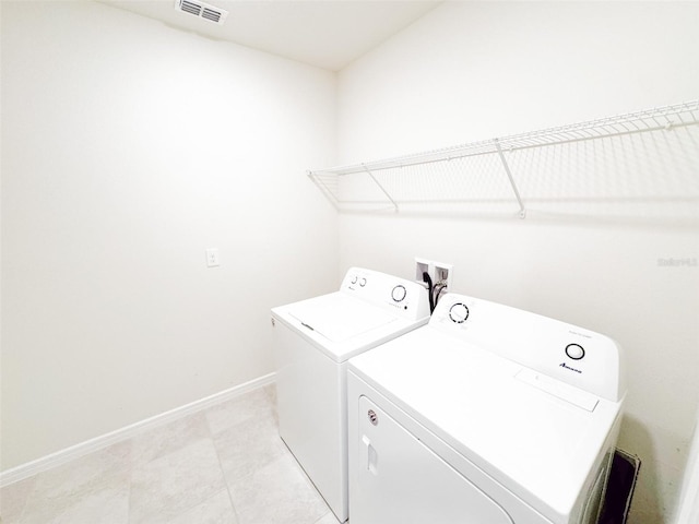 398 Citrus Isle Loop, Davenport, FL 33837 - laundry area featuring washing machine and dryer, baseboards, and light tile patterned flooring