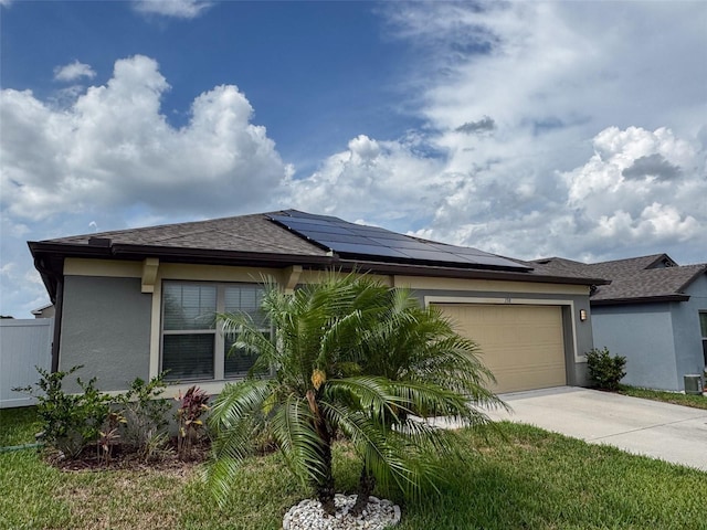 398 Citrus Isle Loop, Davenport, FL 33837 - view of front of house featuring stucco siding, concrete driveway, and roof mounted solar panels