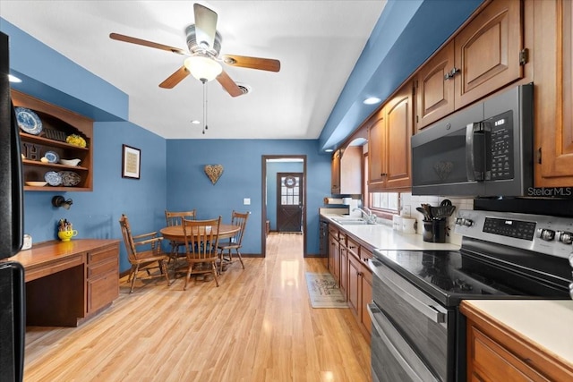2020 Geronimo Trl, Maitland, FL 32751 - kitchen with range with two ovens, black microwave, a sink, and brown cabinets
