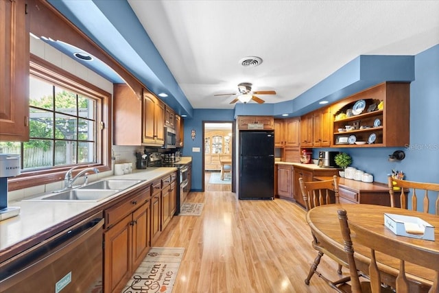 2020 Geronimo Trl, Maitland, FL 32751 - kitchen featuring stainless steel appliances, a sink, light wood finished floors, brown cabinetry, and light countertops