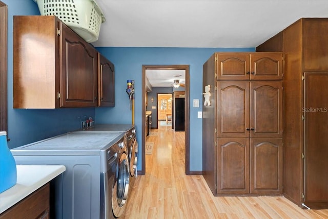2020 Geronimo Trl, Maitland, FL 32751 - washroom with cabinet space, washer and clothes dryer, and light wood-type flooring