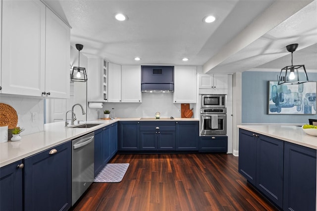 120 Springwood Trl, Altamonte Springs, FL 32714 - kitchen with stainless steel appliances, blue cabinetry, a sink, dark wood-style floors, and recessed lighting