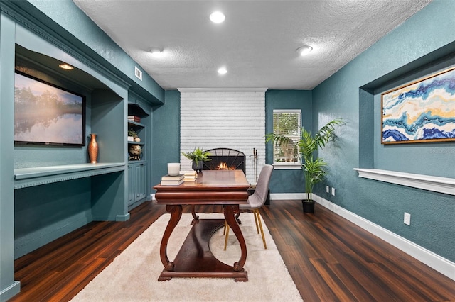 120 Springwood Trl, Altamonte Springs, FL 32714 - office space with a textured wall, dark wood finished floors, a fireplace, a textured ceiling, and baseboards