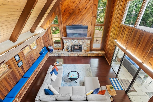 120 Springwood Trl, Altamonte Springs, FL 32714 - living area with wooden walls, wood finished floors, a stone fireplace, and wooden ceiling with exposed beams