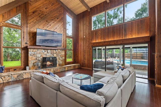 120 Springwood Trl, Altamonte Springs, FL 32714 - living area featuring high vaulted ceiling, wooden walls, wooden ceiling with exposed beams, dark wood finished floors, and a fireplace