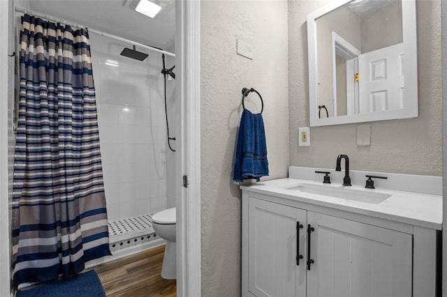 120 Springwood Trl, Altamonte Springs, FL 32714 - bathroom with a textured wall, toilet, tiled shower, vanity, and wood finished floors