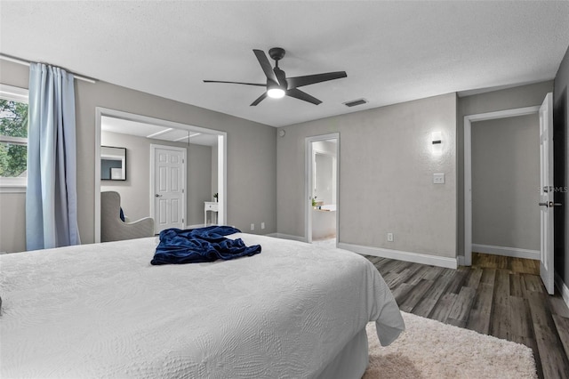 120 Springwood Trl, Altamonte Springs, FL 32714 - bedroom with wood finished floors, baseboards, ceiling fan, ensuite bath, and a textured ceiling