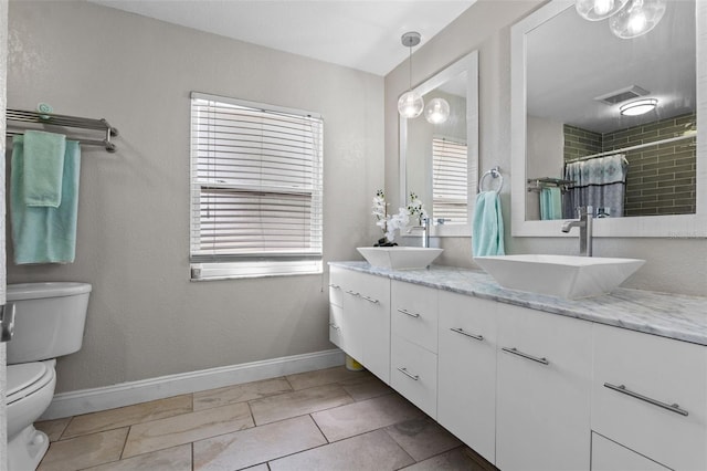 120 Springwood Trl, Altamonte Springs, FL 32714 - bathroom with toilet, double vanity, a tile shower, and baseboards