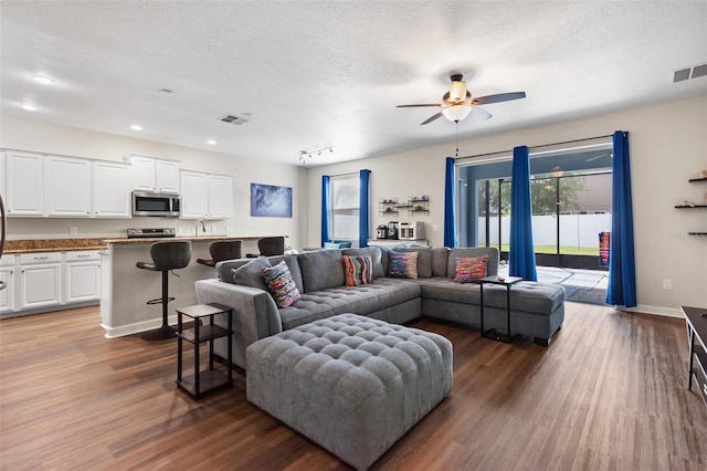 6333 Schoolhouse Pond Rd, Winter Garden, FL 34787 - living area featuring dark wood-style floors, ceiling fan, recessed lighting, a textured ceiling, and baseboards