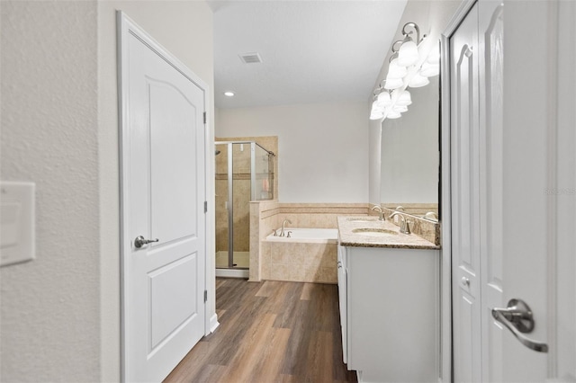 6333 Schoolhouse Pond Rd, Winter Garden, FL 34787 - full bath featuring a shower stall, a garden tub, vanity, and wood finished floors