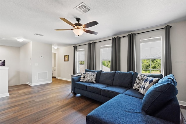 6333 Schoolhouse Pond Rd, Winter Garden, FL 34787 - living room with wood finished floors, ceiling fan, a textured ceiling, and baseboards