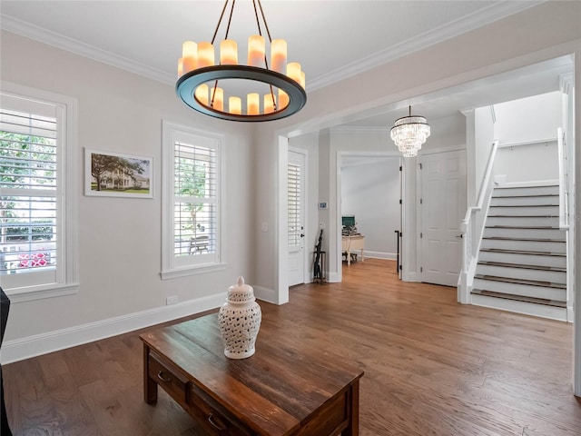 1438 Stickley Ave, Celebration, FL 34747 - living area featuring a chandelier, wood finished floors, baseboards, crown molding, and stairway