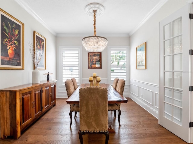 1438 Stickley Ave, Celebration, FL 34747 - dining space featuring a chandelier, crown molding, wood finished floors, wainscoting, and a decorative wall