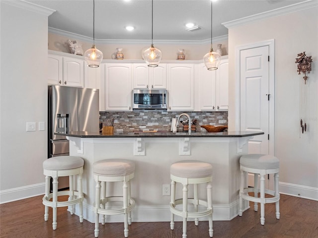 1438 Stickley Ave, Celebration, FL 34747 - kitchen with stainless steel appliances, a kitchen breakfast bar, decorative backsplash, dark countertops, and recessed lighting