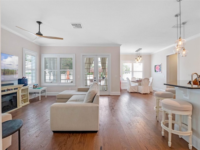 1438 Stickley Ave, Celebration, FL 34747 - living area featuring ornamental molding, dark wood-style floors, baseboards, ceiling fan, and french doors