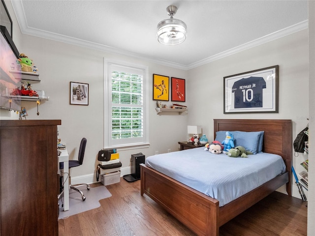 1438 Stickley Ave, Celebration, FL 34747 - bedroom featuring wood finished floors, crown molding, and baseboards