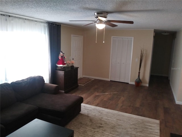 943 Millenbeck Ave, Deltona, FL 32725 - living area with ceiling fan, wood finished floors, baseboards, and a textured ceiling
