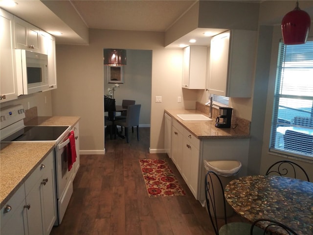 943 Millenbeck Ave, Deltona, FL 32725 - kitchen with white appliances, a sink, white cabinetry, dark wood-style flooring, and baseboards