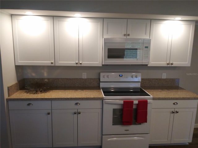 943 Millenbeck Ave, Deltona, FL 32725 - kitchen featuring white appliances, white cabinetry, and light countertops