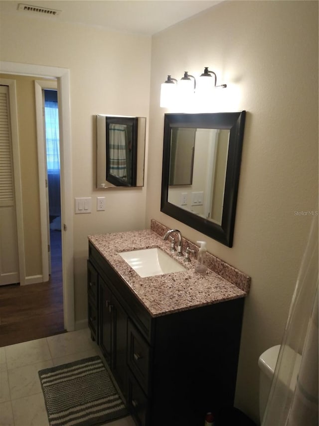 943 Millenbeck Ave, Deltona, FL 32725 - bathroom with vanity, toilet, and baseboards