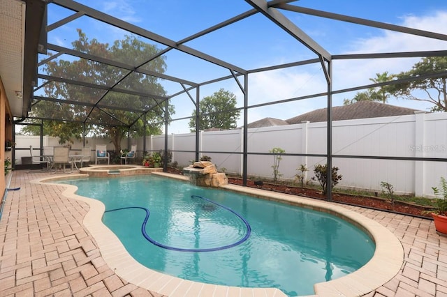 314 Edgewood Ct, Kissimmee, FL 34759 - view of swimming pool featuring a fenced backyard, a patio, glass enclosure, and a pool with connected hot tub