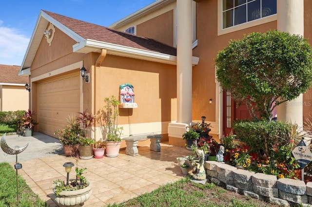 314 Edgewood Ct, Kissimmee, FL 34759 - entrance to property with an attached garage, stucco siding, and roof with shingles