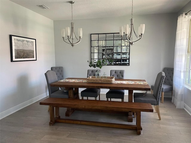 302 Coco Plum Ct, Oldsmar, FL 34677 - dining area featuring a chandelier, light wood-type flooring, and baseboards