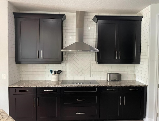 302 Coco Plum Ct, Oldsmar, FL 34677 - kitchen with wall chimney range hood, black electric cooktop, decorative backsplash, light stone counters, and a textured ceiling