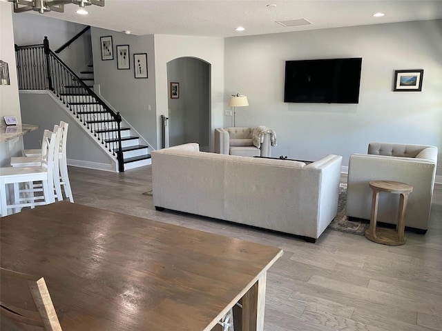 302 Coco Plum Ct, Oldsmar, FL 34677 - living area featuring arched walkways, light wood-type flooring, stairway, recessed lighting, and baseboards