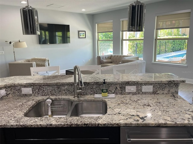 302 Coco Plum Ct, Oldsmar, FL 34677 - kitchen with a sink, dishwashing machine, light stone counters, open floor plan, and recessed lighting