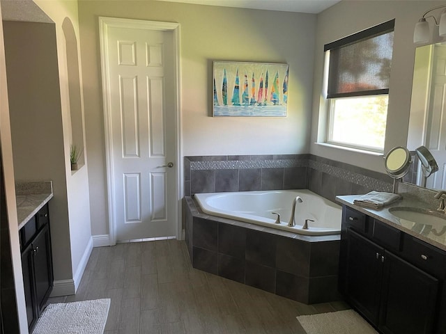 302 Coco Plum Ct, Oldsmar, FL 34677 - bathroom featuring vanity, a bath, and wood finished floors