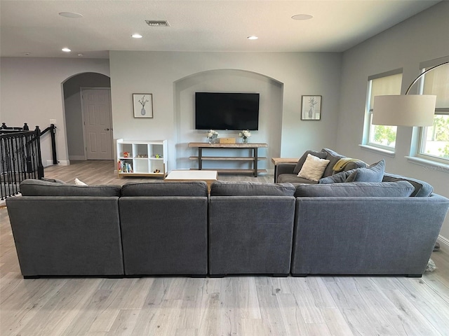 302 Coco Plum Ct, Oldsmar, FL 34677 - living area featuring arched walkways, wood finished floors, recessed lighting, and baseboards