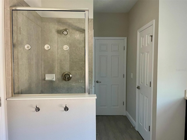 302 Coco Plum Ct, Oldsmar, FL 34677 - full bath with a tile shower, wood finished floors, and baseboards