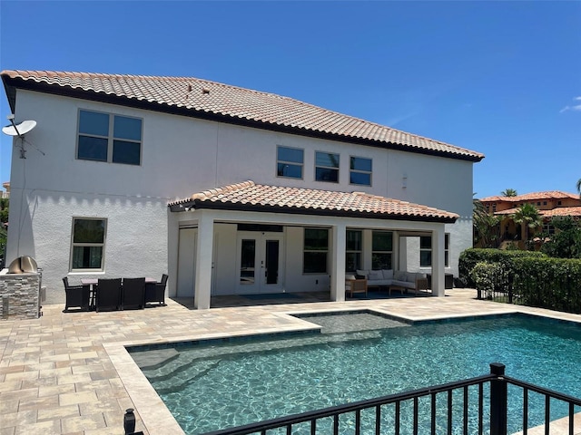 302 Coco Plum Ct, Oldsmar, FL 34677 - back of property with outdoor lounge area, french doors, a tiled roof, and a patio