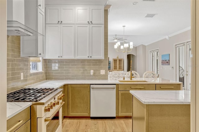 11721 Camden Park Dr, Windermere, FL 34786 - kitchen featuring white appliances, wall chimney range hood, crown molding, a peninsula, and backsplash