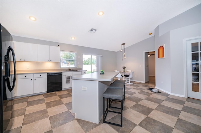146 Hidden Pointe Ln, Groveland, FL 34736 - kitchen featuring black appliances, vaulted ceiling, a sink, a breakfast bar, and light countertops
